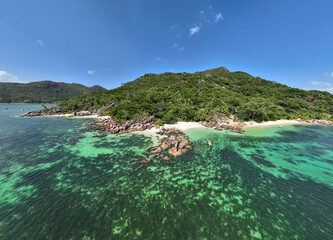 panoramic drone view of the coast of the Seychelles with bays and white catamarans