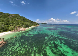 Obraz premium panoramic drone view of the coast of the Seychelles with bays and white catamarans
