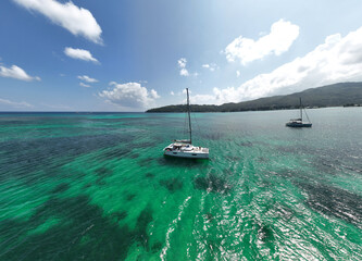 panoramic drone view of the coast of the Seychelles with bays and white catamarans