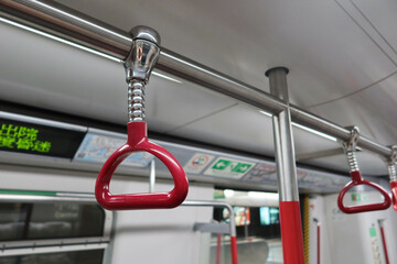 Central Station, Hong Kong- 16 Feb 2024: close up of red handle on the Hong Kong MTR Railway train
