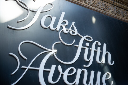 shallow depth of field focus on Saks Fifth Avenue, a posh department store chain, sign located at 176 Yonge Street in downtown Toronto, Canada