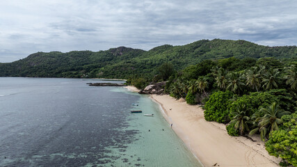 panoramic drone view of the coast of the Seychelles with bays and white catamarans