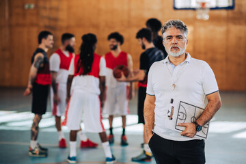 Portrait of senior basketball coach on court during the training.