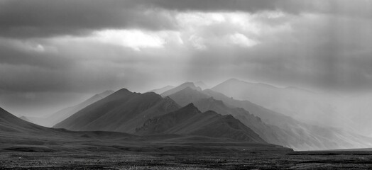 black and white landscape of twilight mountains in the haze of rain