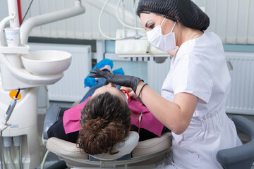 Stomatology and tooth care. Dentistry and oral health. Woman have teeth examination at dentistry clinic. Closeup young caucasian girl face.