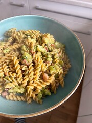 fusilli pasta, gimlet pasta with broccoli, pasta with pesto sauce and broccoli, small pieces of bacon, hot pasta on a plate