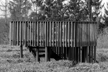 Wooden bridge in the park. Black and white photo with selective focus.