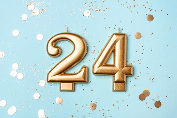 24 years celebration. Greeting banner. Gold candles in the form of number twenty four on peach...