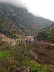 Little village between cloudy mountains