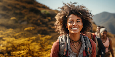 Young woman smiling during a nature hike with some friends