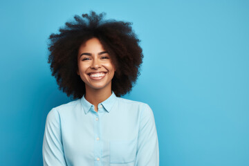 Obraz na płótnie Canvas Smiling woman with curly hair in blue shirt.