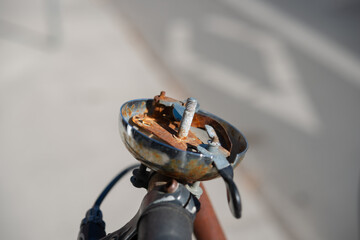 Vintage bike bell missing its distinctive top piece, revealing the inner workings and character of a bygone era
