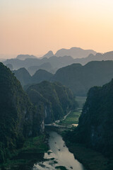 Viewpoint Đầm sen Hang múa is a popular spot for tourists visiting Tam Coc in the Ninh Binh region of Vietnam. In the background are the mountains and rice fields of the region. - obrazy, fototapety, plakaty