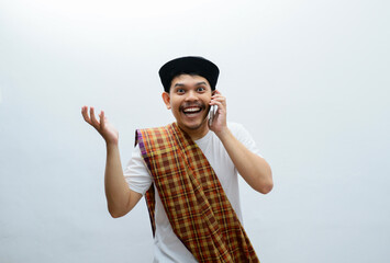 asian muslim man showing happy facewhile holding smartphone