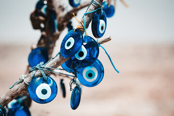 Traditional Turkish amulet Evil Eye or blue eye (Nazar boncugu) on tree brunch. Traditional Turkish...