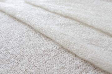 background of white knitted   soft fabric in a fold
