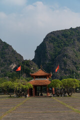 Blue skies and green vegitation surround the Temple of Empeor Le Dai Hahn in Ninh Binh region of Vietnam
