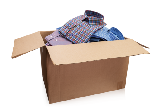 Open cardboard box full of men's folded shirts isolated on white background