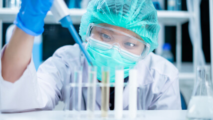 Nutritionist or scientist dripping dairy milk to checking the quality and temperature. Concept of nutrition, lactose, protein, bacteria, fat and glucose laboratory. Dairy milk test and research.