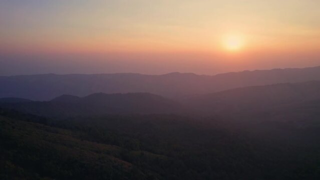 Colorful sunrise over mountain range in tropical rainforest at Phu Lom Lo, Phu Hin Rong Kla national park