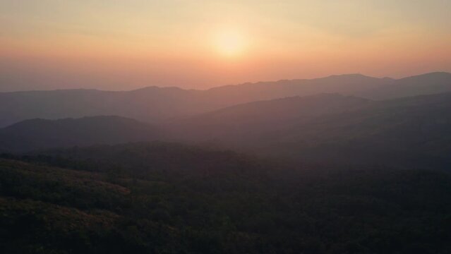 Colorful sunrise over mountain range in tropical rainforest at Phu Lom Lo, Phu Hin Rong Kla national park