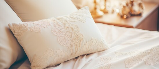 This close-up view displays a bed with a pristine white comforter, adorned with a beautiful luxury pillow in a bedroom interior. Light vintage filter enhances the cozy atmosphere.