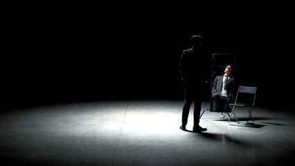 Man in suit alone on theater stage. Stock footage. Single attractive man in suit is playing on stage of theater. Man in suit with mirror is alone on dark theatrical stage