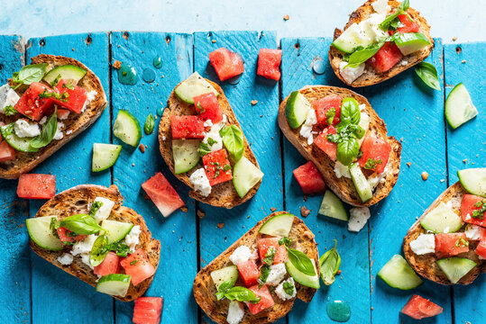 Bruschetta with watermelon, feta cheese, cucumber and basil