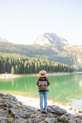 Active woman enjoys the beautiful scenery of the majestic mountains. Travel, adventure. 