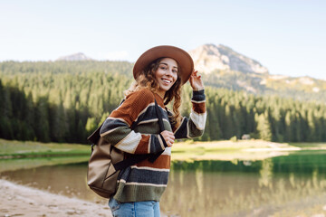 Active woman enjoys the beautiful scenery of the majestic mountains. Travel, adventure. 