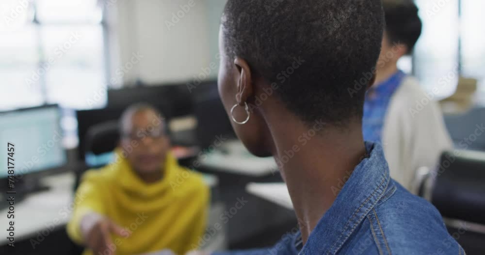 Aufkleber animation of data processing over diverse colleagues working in creative office