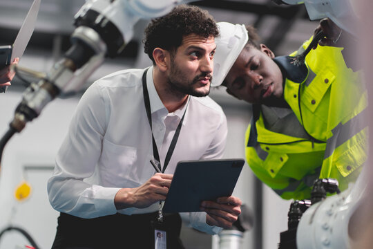 Professional smart robotic engineering team are working and discussing with robotic process or checking, concept of examining manufacturing innovation or invention, technician of futuristic automated. - Powered by Adobe