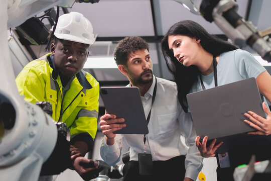 Professional smart robotic engineering team are working and discussing with robotic process or checking, concept of examining manufacturing innovation or invention, technician of futuristic automated.