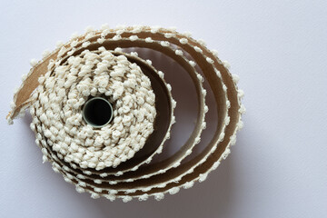 spirals emerging from a spool of decorative ribbon