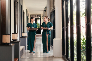 Portrait two Asian woman professional masseuse prepare spa set for massage service customer in...