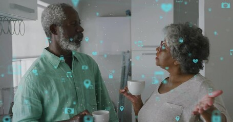 Animation of network of connections with icons over senior african american couple talking - Powered by Adobe