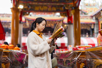 Asian woman pray in Chinese temple