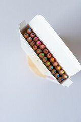 top-down view of color pencil box with tabs and flap open