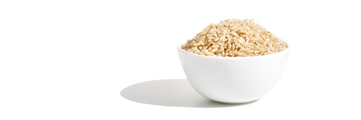 A bowl of uncooked brown rice, isolated against a white background. Healthy, savory dish includes...