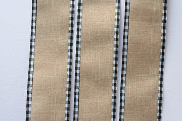 vertical lengths of ribbon with plaid ribbing on paper