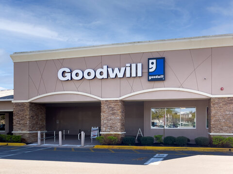 PORT CHARLOTTE, FLORIDA - FEBRUARY 29, 2024 : Goodwill thrift store building storefront facade with logo. Goodwill Industries operates nonprofit second hand clothing and hard goods retail stores.