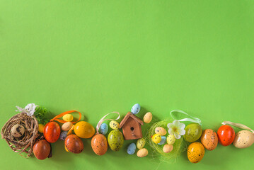 Happy easter holidays concept; Frame of easter eggs on green background, copy space