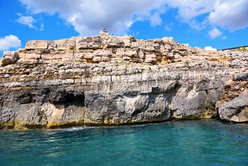 Fototapeta na wymiar The caves of the ionian Sea side of Santa Maria di Leuca seen from the tourist boat 