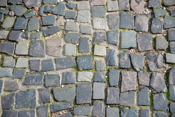 Stone wall with old bricks in the city. Gray stone block surface.