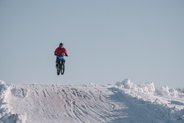 Group of motorcycle racers winter race enduro. Winter motocross. Racers ride on ice. Winter sports.