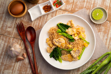 Stir fried Rice Vermicelli with sliced chicken breast,stir fried noodle with garlic ,Sweet Black Soy Sauce ,kale and egg with soy sauce (Pad See Ew).Thai style healthy low fat food.Top view © Kritchai