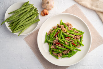 Stir Fried french green beans and Minced Pork with oyster sauce in white plate.Top view