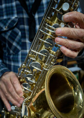 Hands and Saxophone in Focus