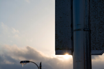 silhouettes of the street lamp and the signboard - Powered by Adobe