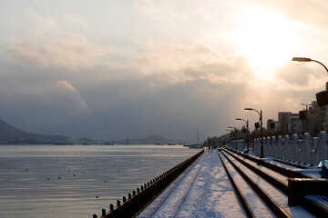 Snow-covered riverside in dusk